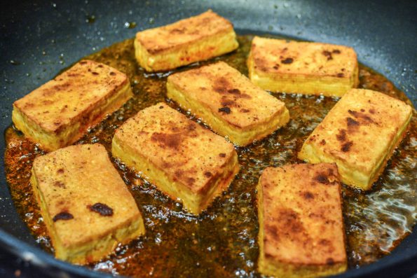 Tofu frying in a pan